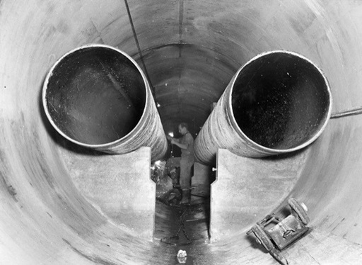 Two very large pipes in tunnel during construction. | Newsreel