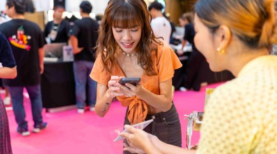 Couple at event using technology. | Newsreel