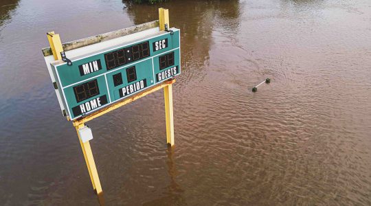 Scoreboard on flooded field. | Newsreel