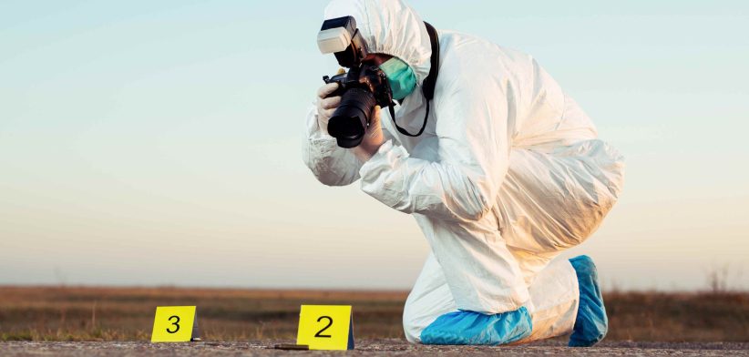 Forensic scientist taking photos at crime scene. | Newsreel