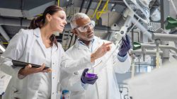 Two people in lab. | Newsreel