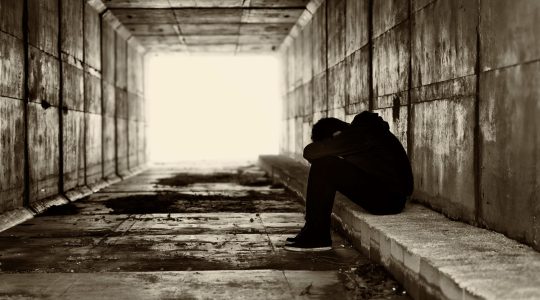 Sad young person in tunnel. | Newsreel