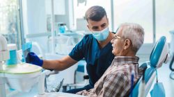 Dentist with elderly patient. | Newsreel