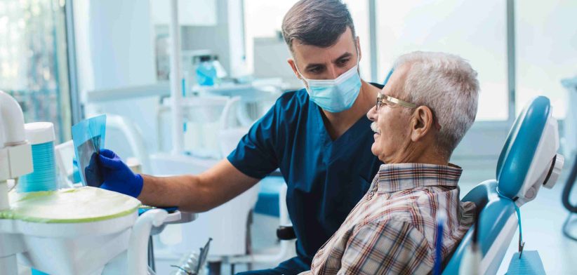 Dentist with elderly patient. | Newsreel
