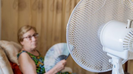 Elderly lady with electric fan. | Newsreel