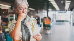 Worried woman looks at shopping receipt. | Newsreel