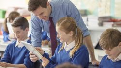 Teacher with students in classroom. | Newsreel