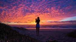 Woman on beach at sunset. | Newsreel