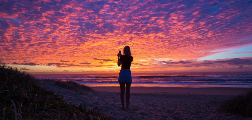 Woman on beach at sunset. | Newsreel