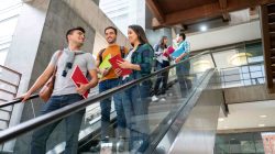 Students on escalator. | Newsreel
