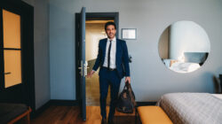 Man walking into office with briefcase. | Newsreel