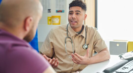 Doctor and patient in consultation. | Newsreel