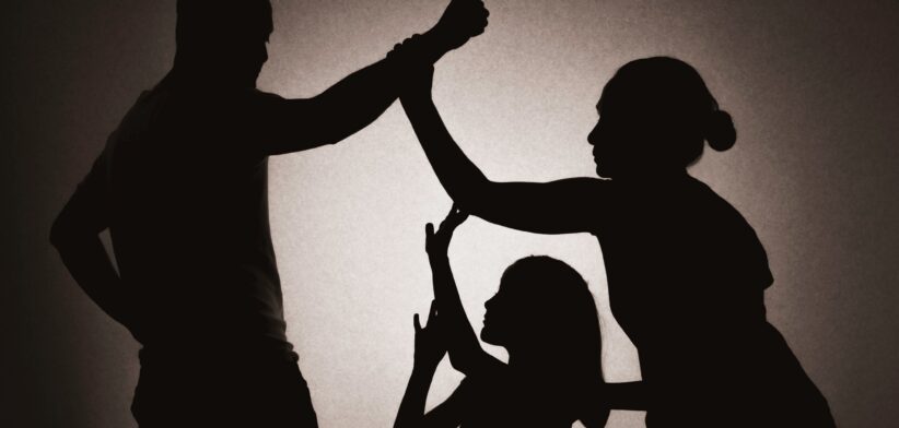 Silhouette of man abusing woman and child. | Newsreel