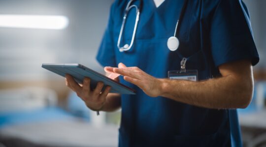 Health care worker looking at iPad | Newsreel