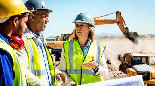 Mine managers in hard hats and hi-viz. | Newsreel