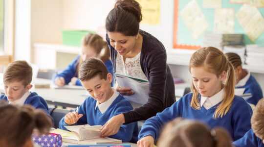 School children and teacher in classroom. | Newsreel