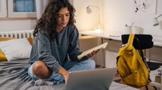 Student in room on computer | Newsreel