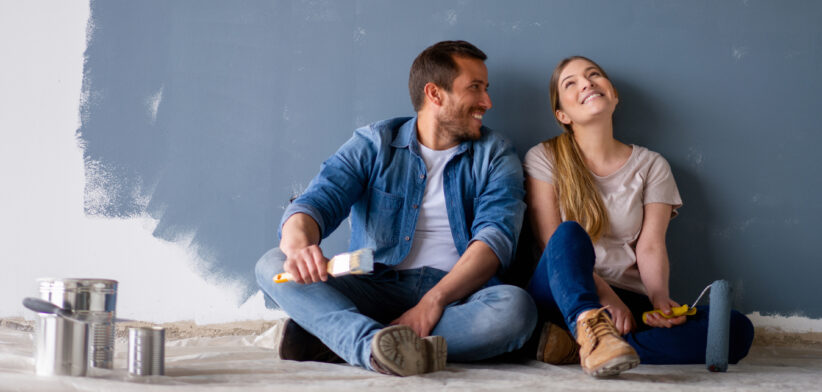 Couple rest after painting room. | Newsreel