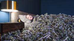 Man sleeping with piles of cash. | Newsreel