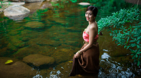 Asian woman in rock pool. | Newsreel