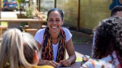 Young Aboriginal woman talking to group. | Newsreel