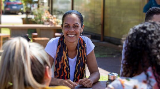 Young Aboriginal woman talking to group. | Newsreel