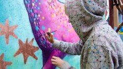 Artist painting mural. | Newsreel