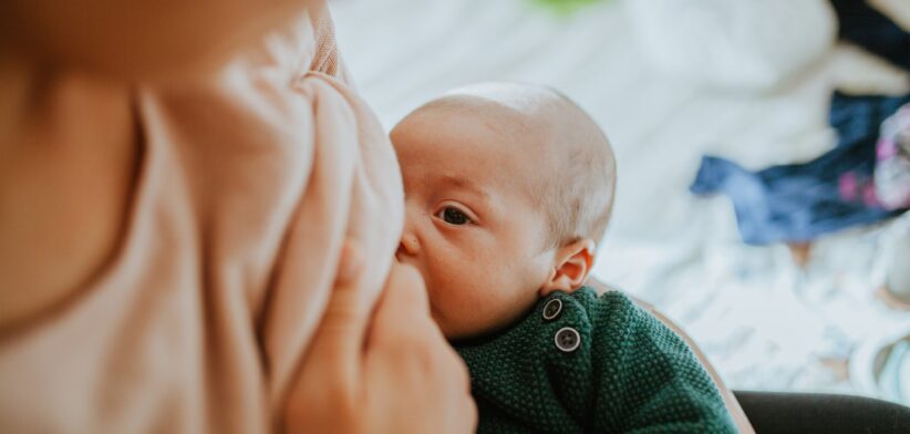A baby breastfeeding/ | Newsreel
