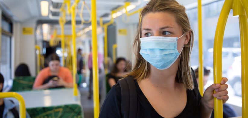 Woman on train wearing mask. | Newsreel