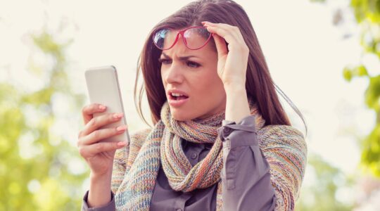 Confused woman looking at mobile phone | Newsreel