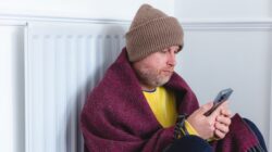 Man rugged up in cold house. | Newsreel