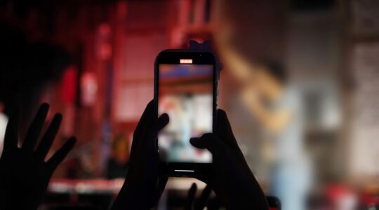 Person shooting on vertical mobile phone. | Newsreel