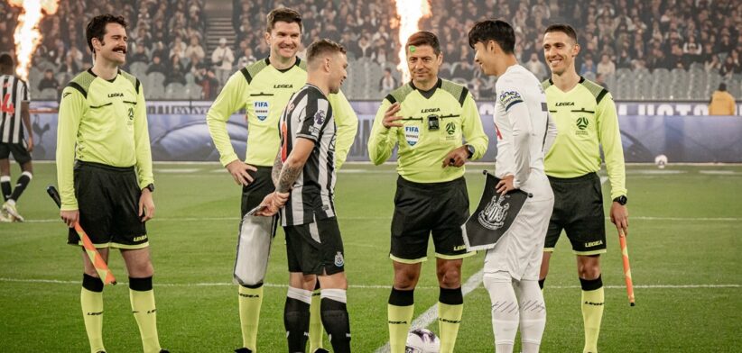 Officials at coin toss of football match Newcastle v Tottenham in Australia.