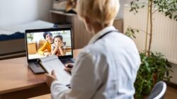 Doctor in telehealth appointment with mother and son. | Newsreel