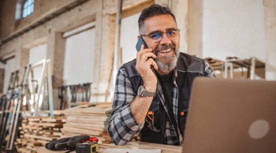 Small business owner on phone. | Newsreel