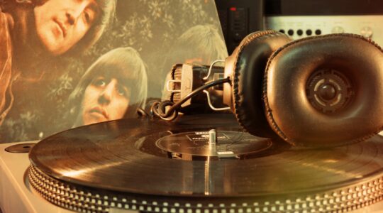 Record player with The Beatles album in background. | Newsreel