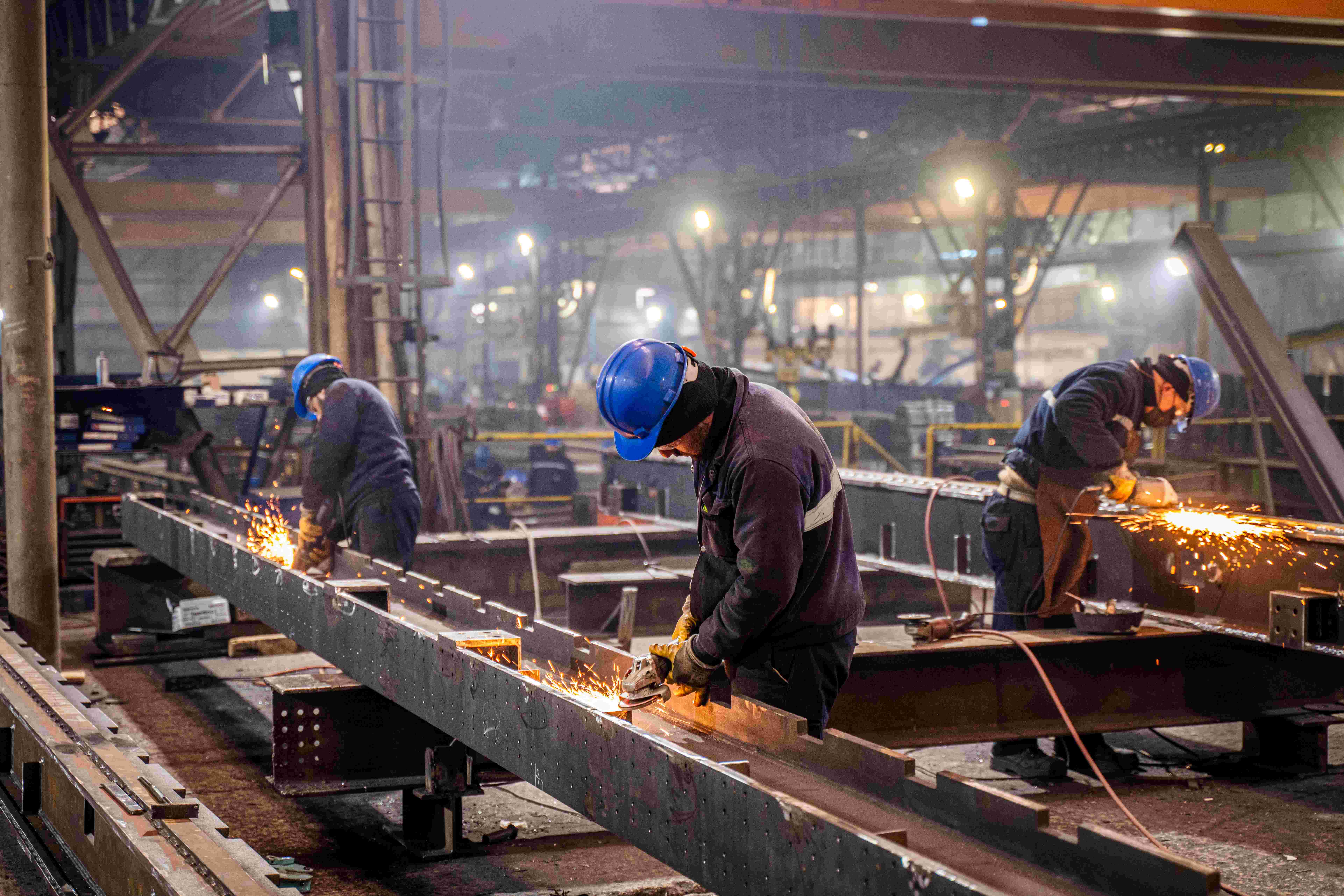 Metal workers using grinders. | Newsreel