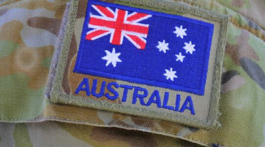 Australian flag on army uniform sleeve. | Newsreel