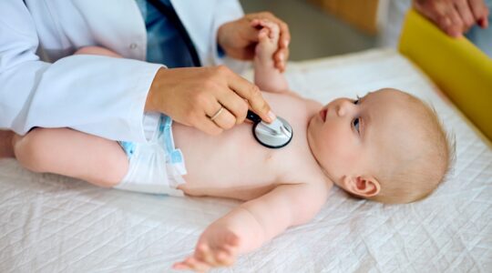 Baby undergoing health check. | Newsreel