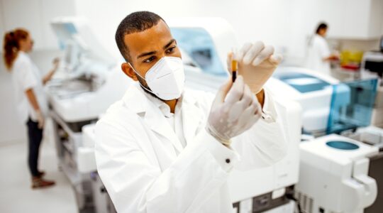 Man in lab testing blood. | Newsreel