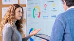 Woman and man looking at business charts.