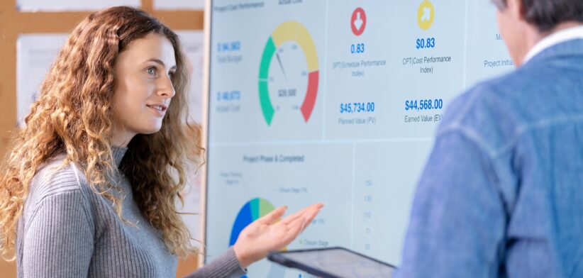 Woman and man looking at business charts.