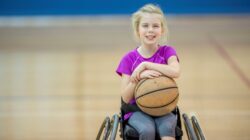 Child in wheelchair with basketball. | Newsreel