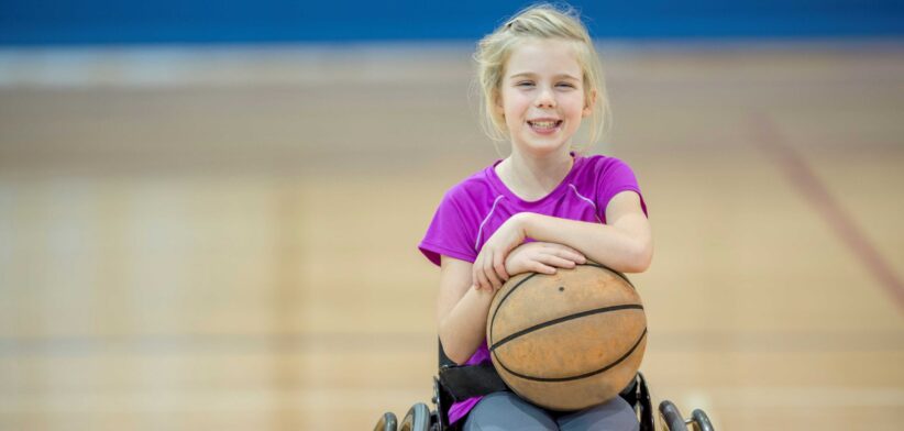 Child in wheelchair with basketball. | Newsreel