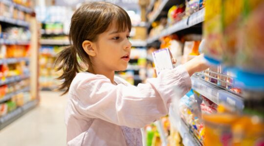 Child shopping in supermarket. | Newsreel