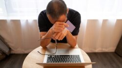 Man unhappy looking at laptop. | Newsreel