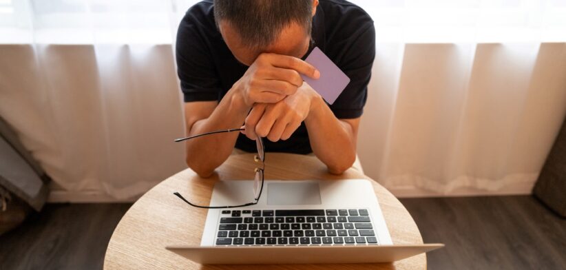 Man unhappy looking at laptop. | Newsreel