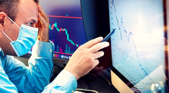 Man with mask looking at investment graph. | Newsreel