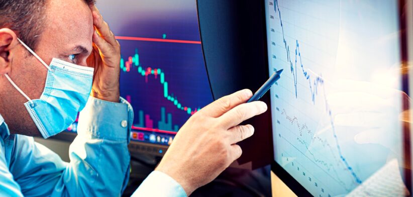 Man with mask looking at investment graph. | Newsreel