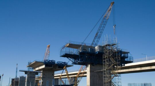 Cranes building a bridge. | Newsreel